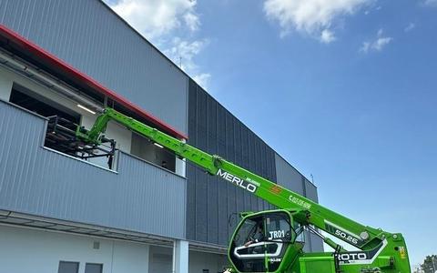 Merlo Roto rotating telehandler placing materials onto an upper floor of a construction site in Johor